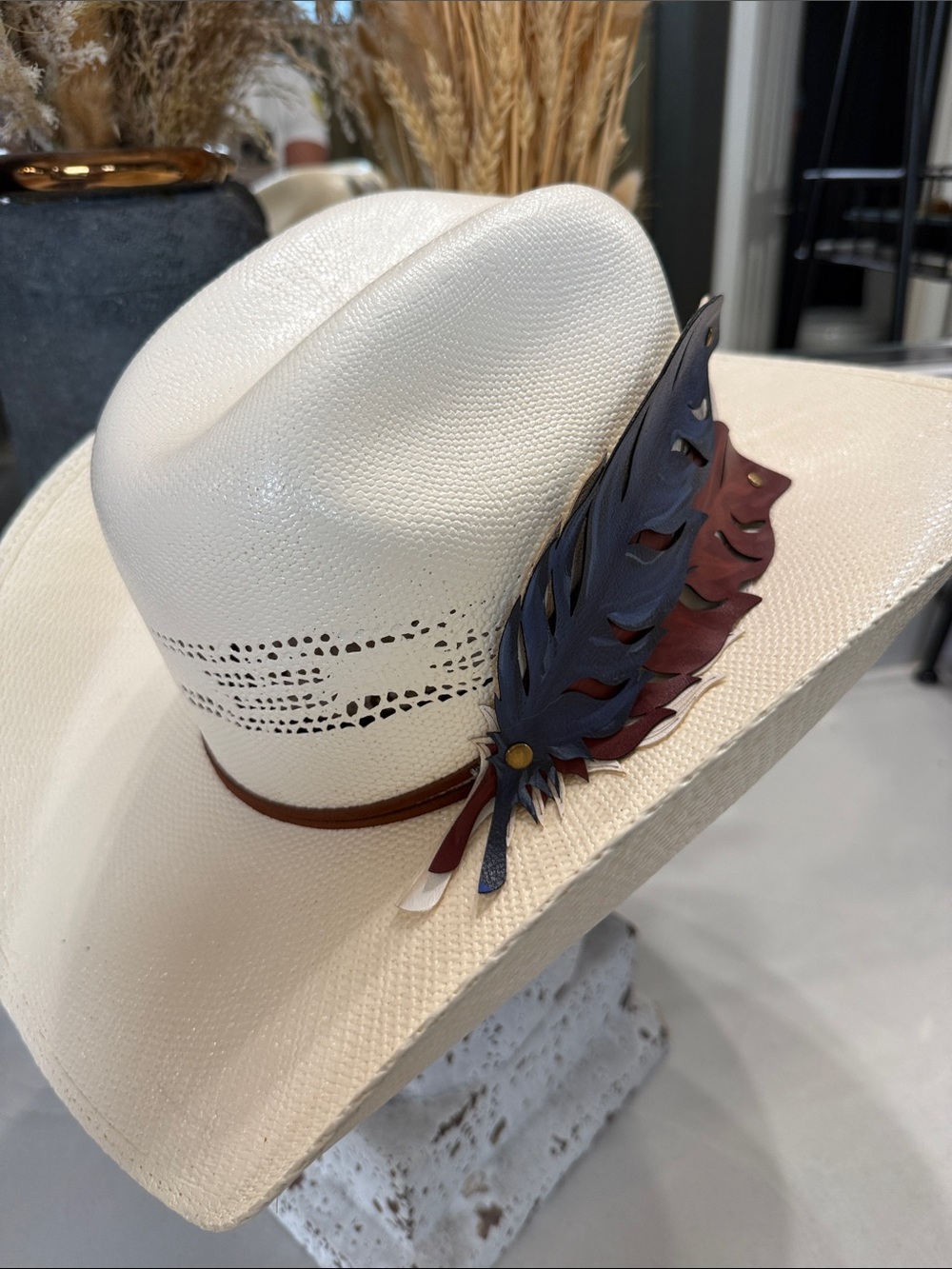 White Straw Cowboy Hat with Patriotic Red White and Blue Feathers.